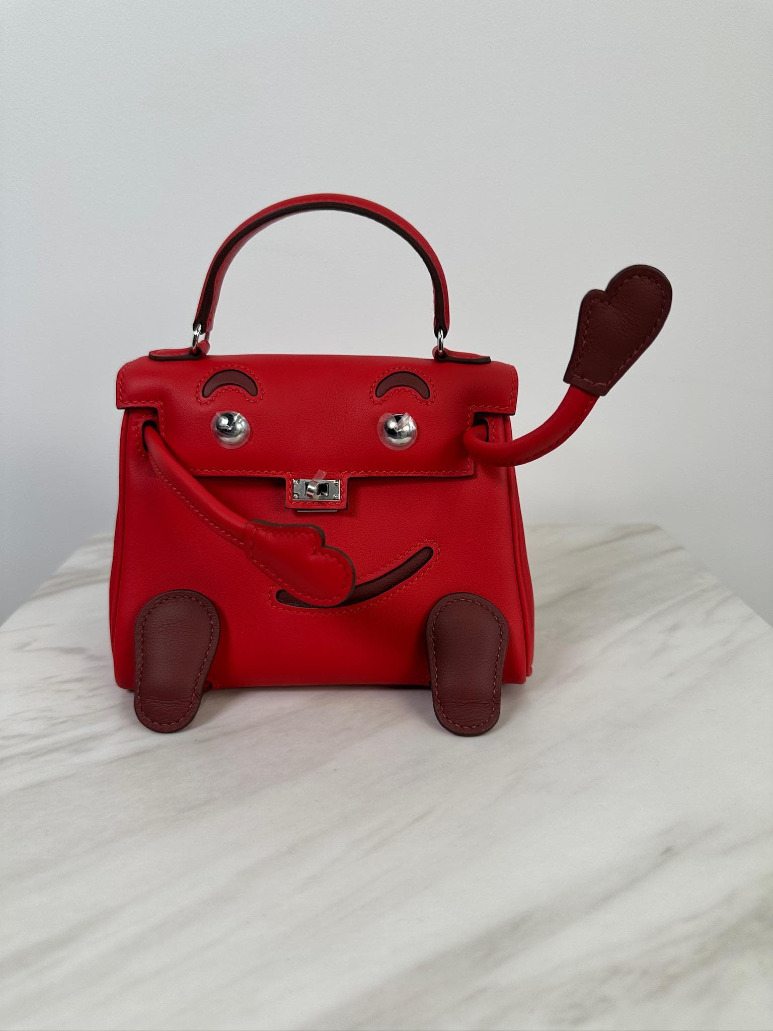 Hermès Mini Kelly Doll Doll in Rouge Radieux Swift Palladium Hardware hardware — front view