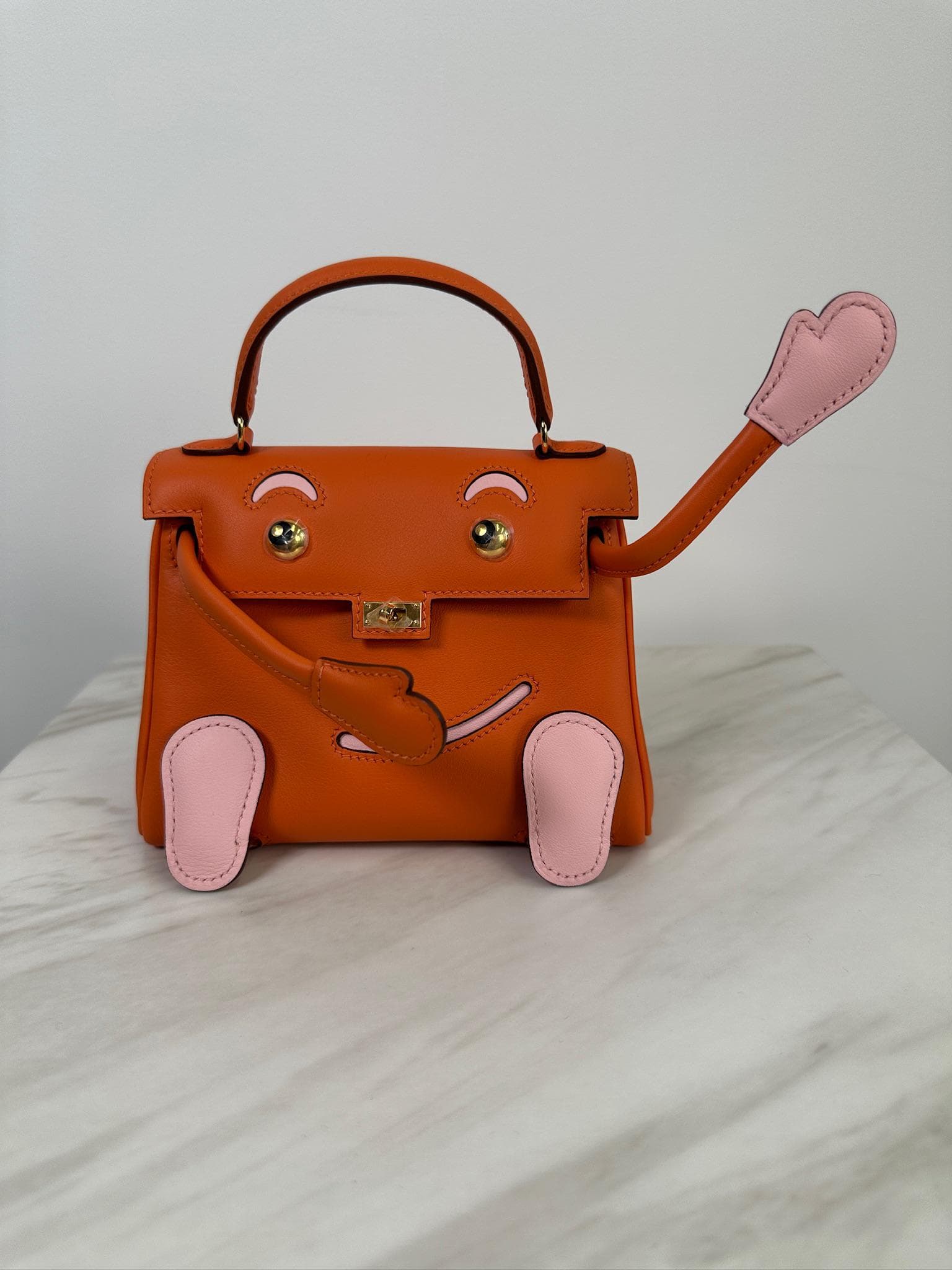 Hermès Mini Kelly Doll Doll in Orange & Rose Sakura Swift Palladium Hardware hardware — front view