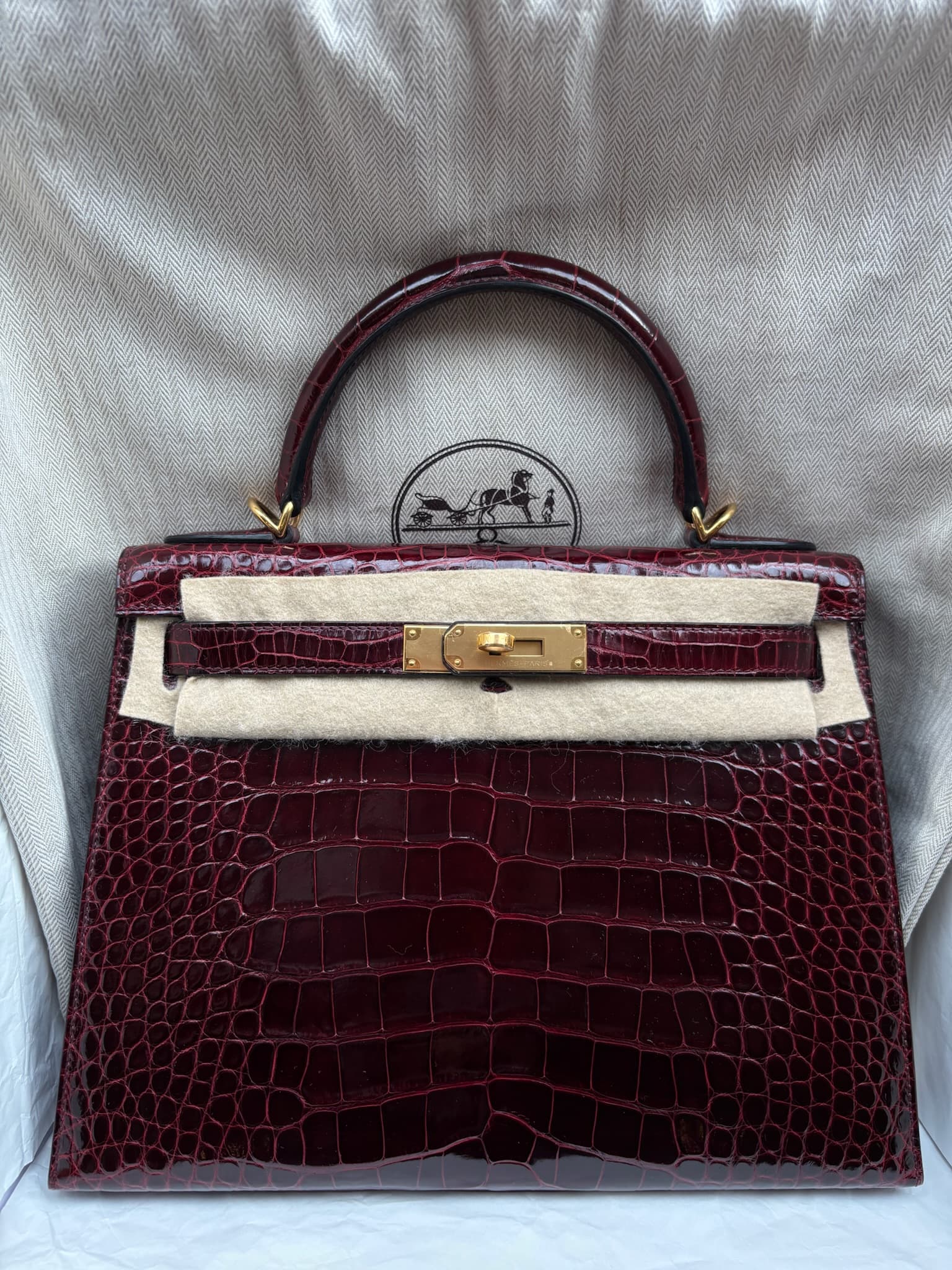 Hermès Kelly 28 in Bordeaux Gold (GHW) hardware — front view