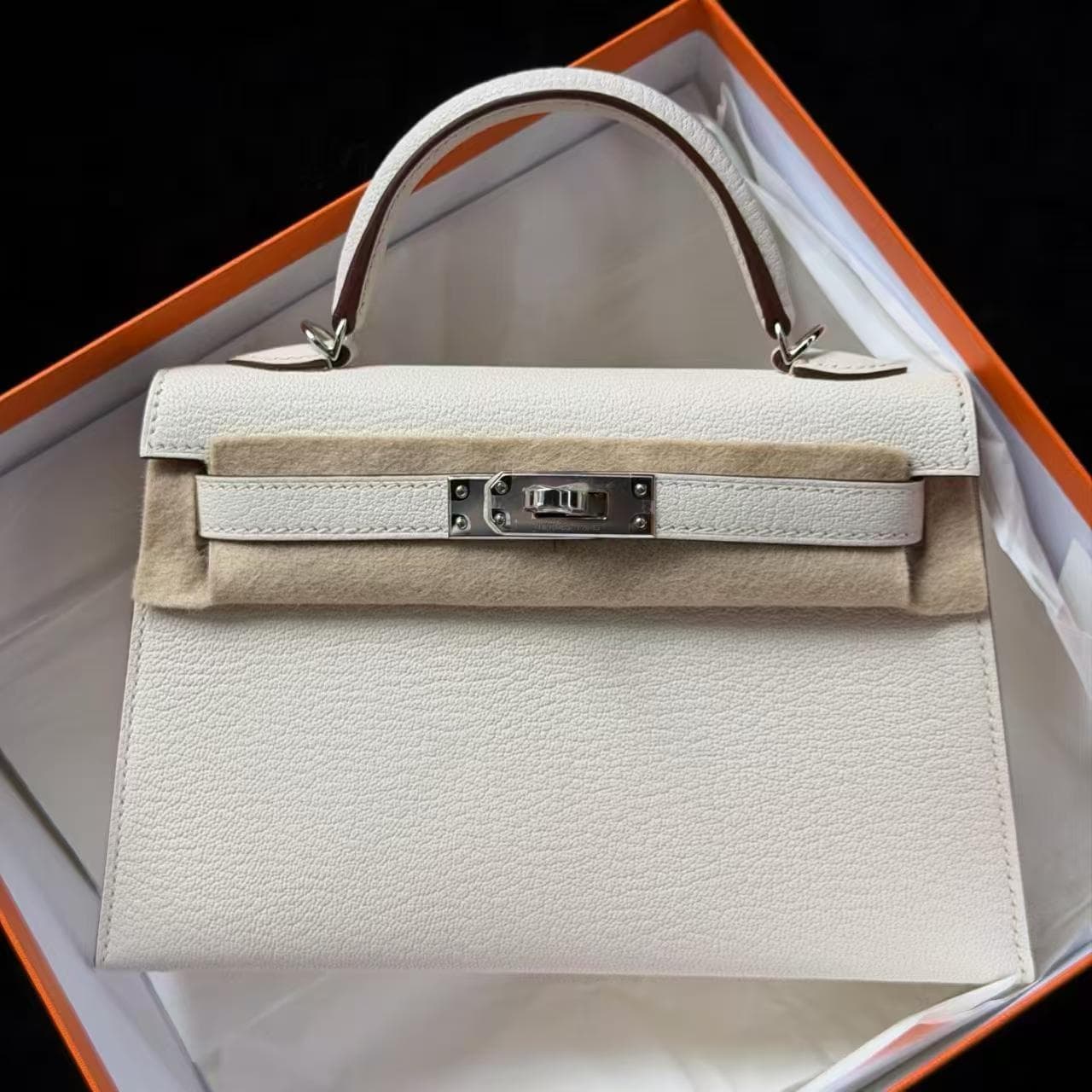 Hermès Kelly Mini Mini in Nata and Rose Extrême Chèvre PHW hardware — front view